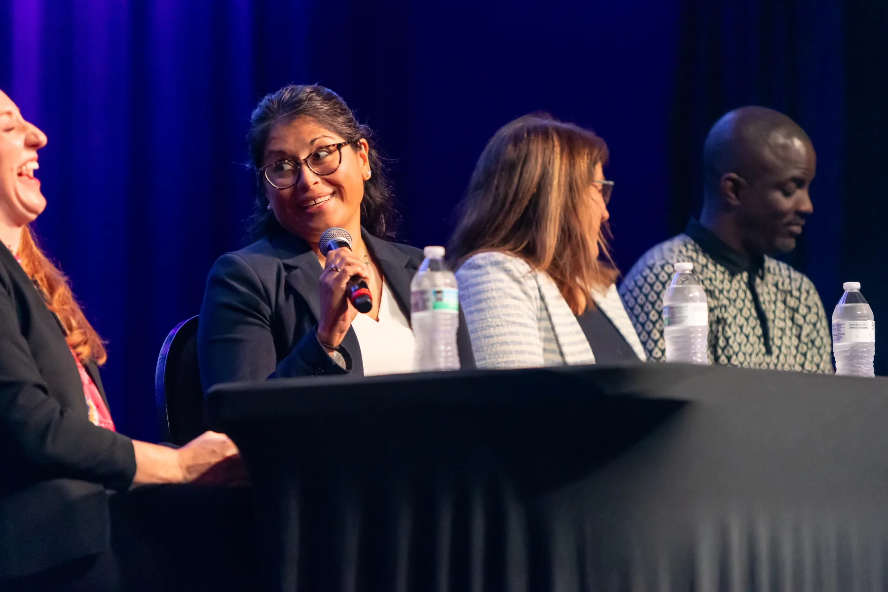 Panelist speaking during a conference discussion