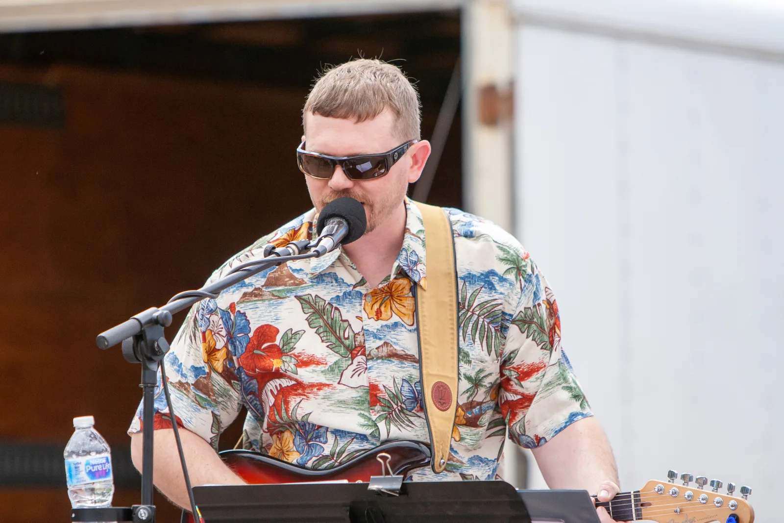 Guitarist singing during an outdoor performance